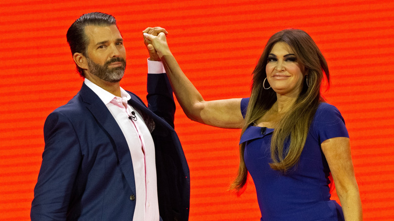 Kimberly Guilfoyle and Donald Trump Jr. awkwardly holding hands