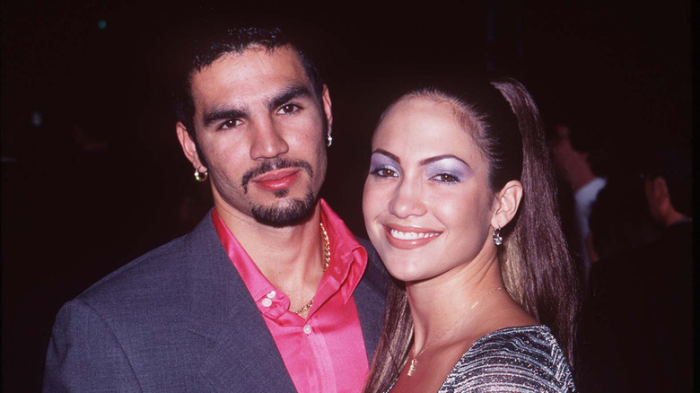 Jennifer Lopez and Ojani Noa smiling for a photo in the '90s