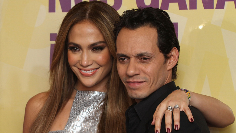 Jennifer Lopez posing with her arm around Marc Anthony