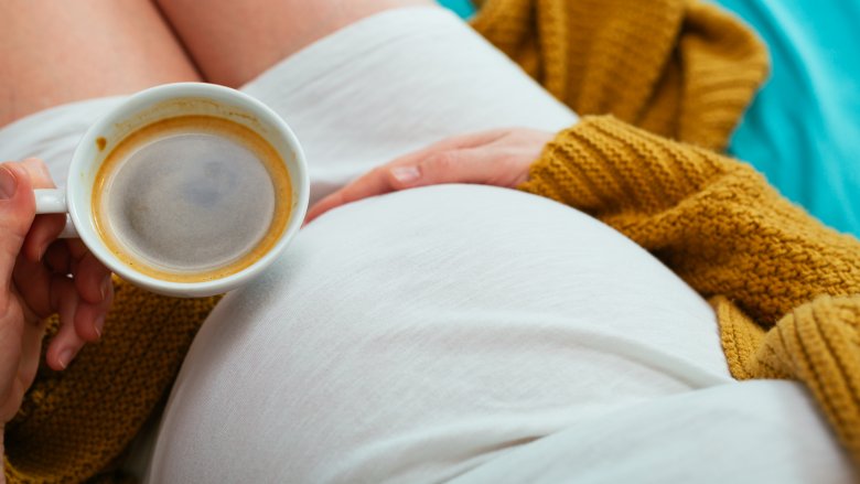 pregnant woman drinking latte