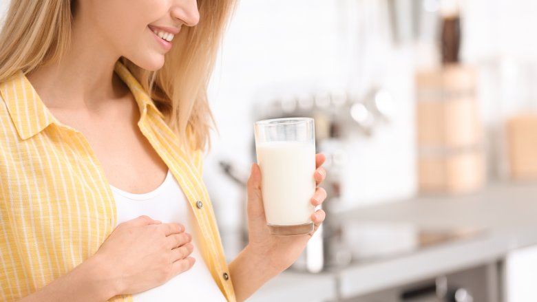 pregnant woman with glass of milk