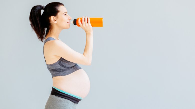 pregnant woman drinking sports drink