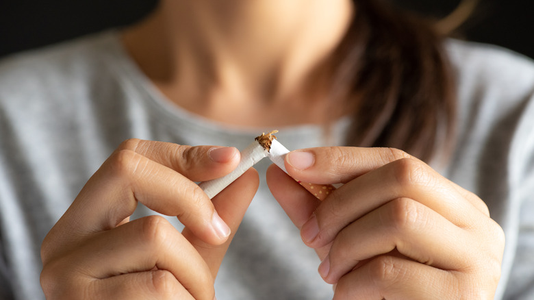 Woman breaking a cigarette