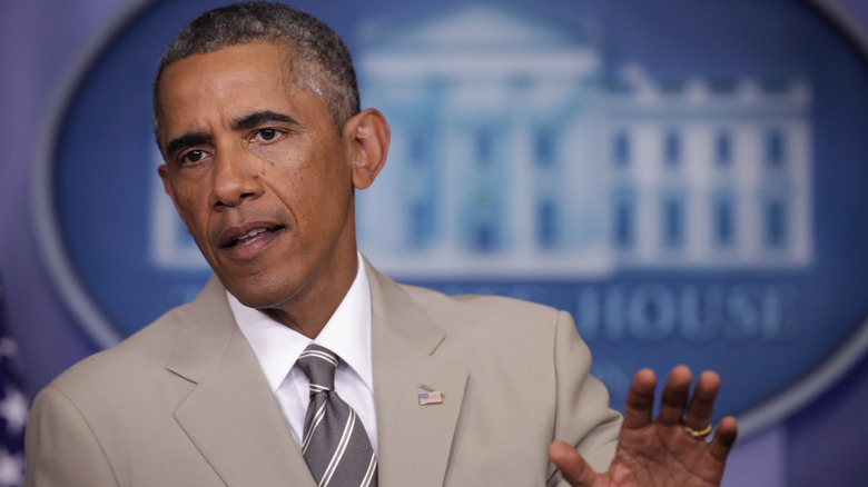 Barack Obama giving a press conference in the White House wearing a tan suit