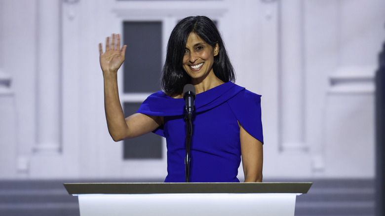 Usha Vance stands at a podium and waves