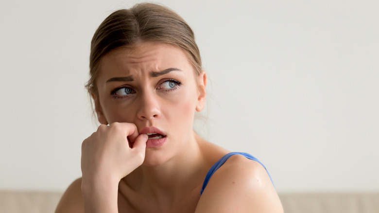 woman biting nails