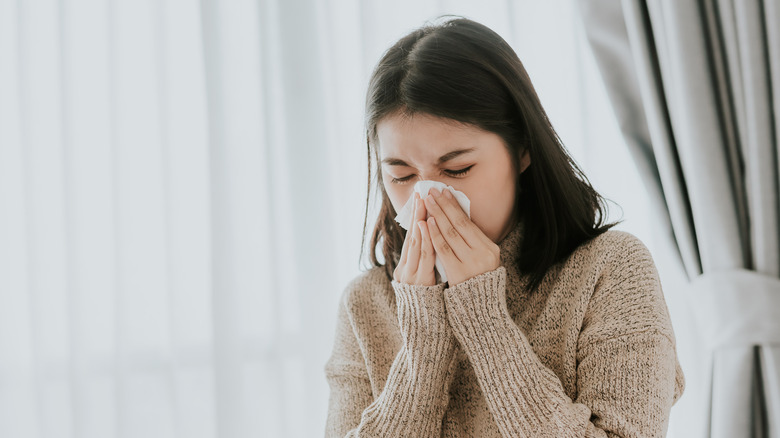 woman blowing nose