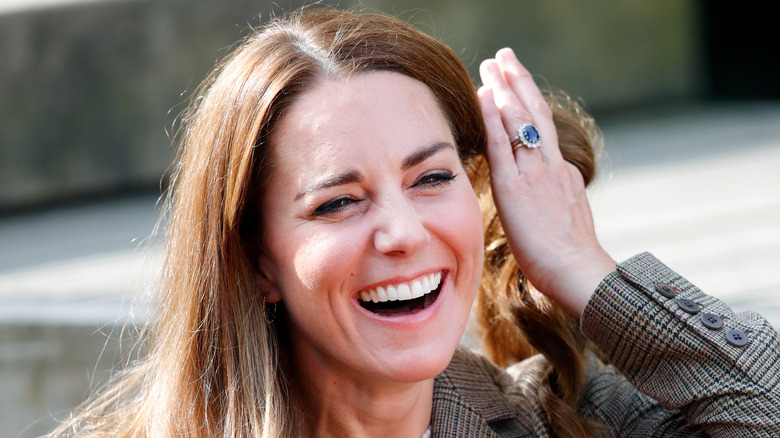 Kate Middleton laughing showing off ring