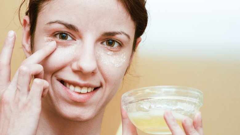 woman applying egg whites to face