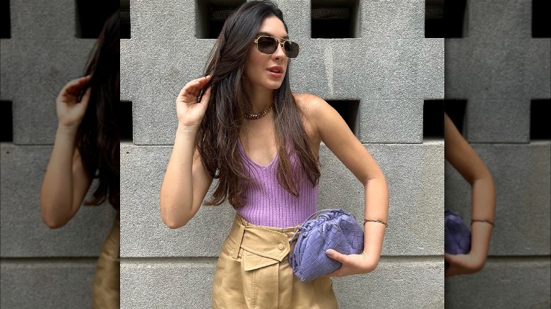 Brunette in purple sweater tank and sunglasses