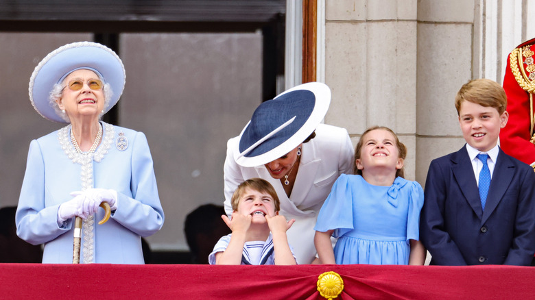 Prince Louis making faces beside Queen Elizabeth II