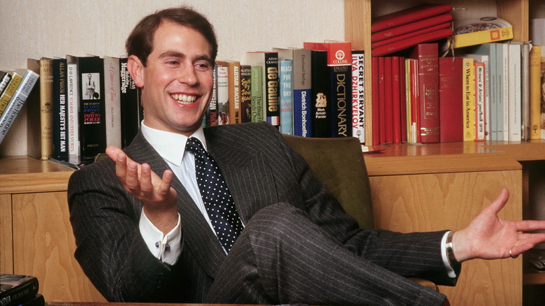 Prince Edward smiling at desk