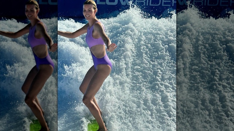 Ivanka Trump surfing in purple swimsuit