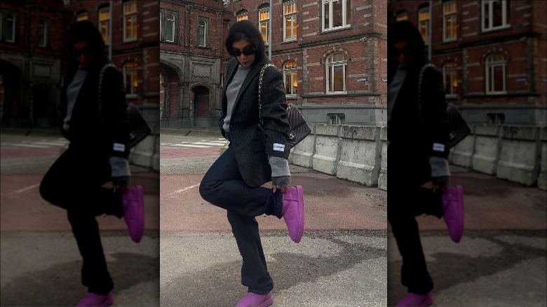 Woman wearing purple Uggs and blazer