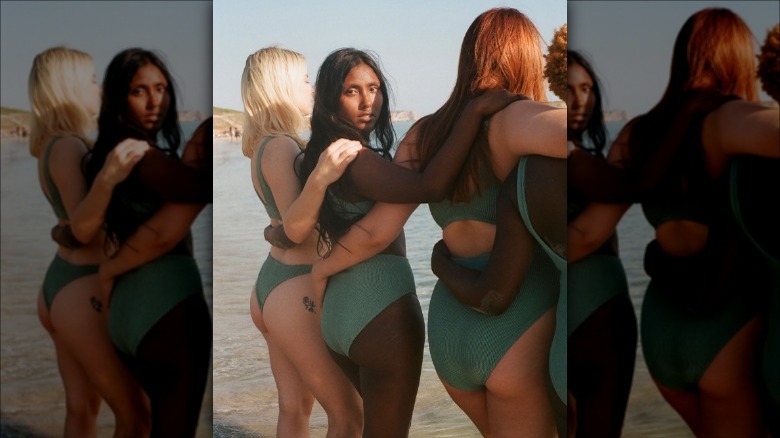 Three women wearing swimsuits 