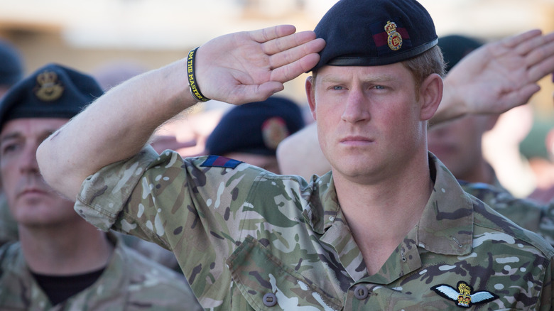 Prince Harry in his military uniform saluting