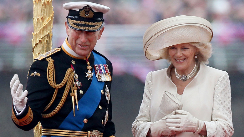 King Charles and Queen Consort, Camilla smiling in hats