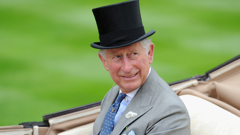 King Charles smiling in top hat