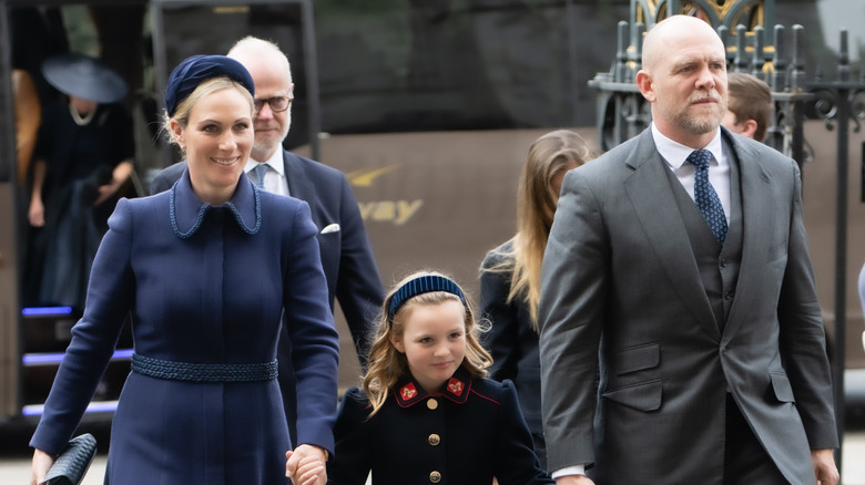 Zara Tindall, Mia Tindall, and Mike Tindall walking together