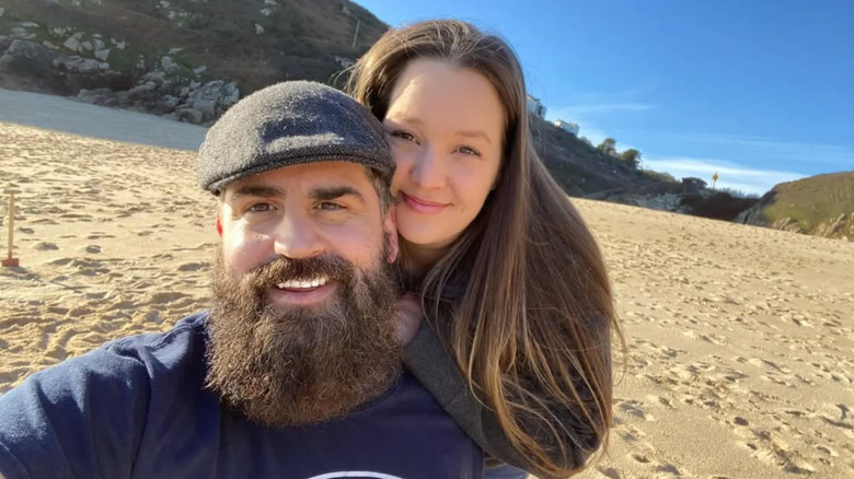 Rachel and Jon Walters smiling on a beach