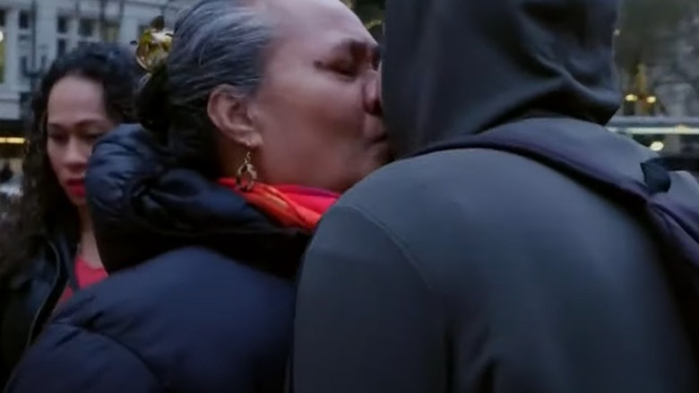 Asuelu's mom kissing him