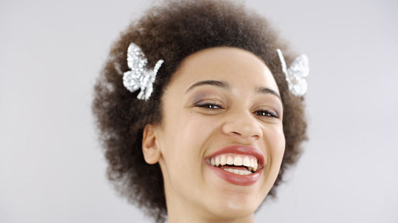 Woman smiling with butterfly clips