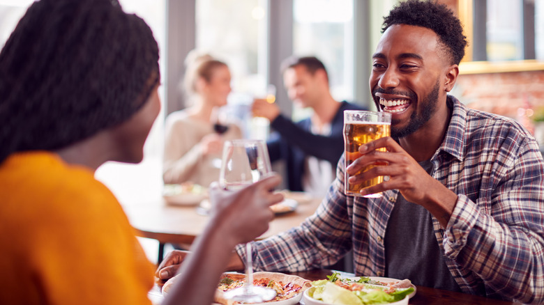 smiling couple drinking at restaurant