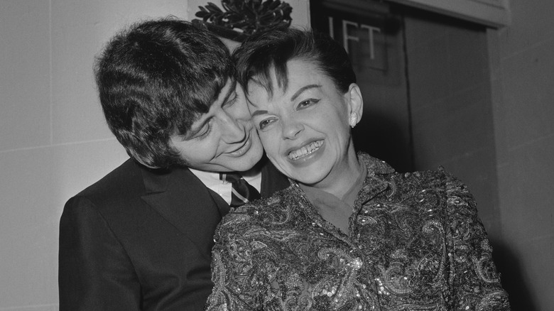 Mickey Deans and Judy Garland smiling and hugging