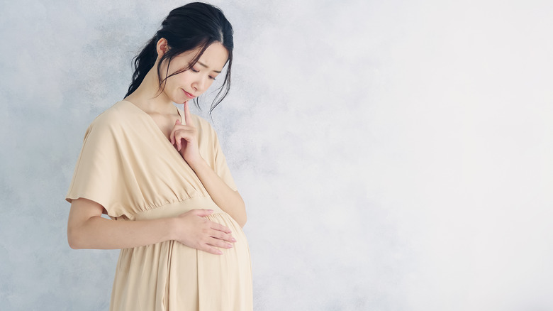 pregnant woman with a hand on her belly