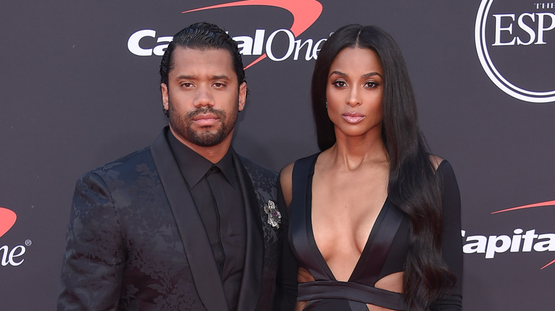 Russell Wilson and Ciara posing on red carpet