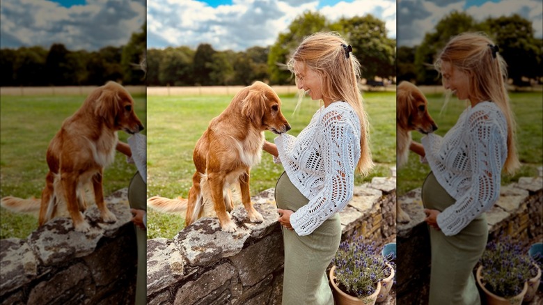 Alizee Thevenet holding baby bump and petting dog