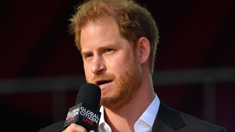 Prince Harry speaking over a microphone