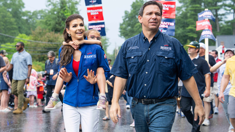 Ron and Casey DeSantis walking with their oldest daughter