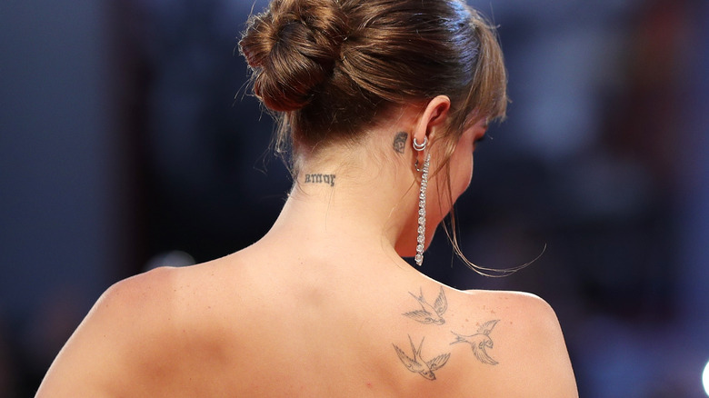 Dakota Johnson's back, showing three tattoos