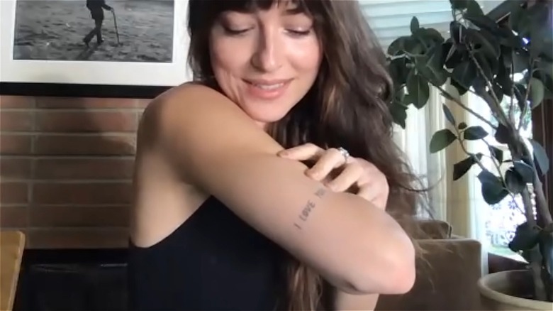 Dakota Johnson shows off "I Love You" tattoo on elbow