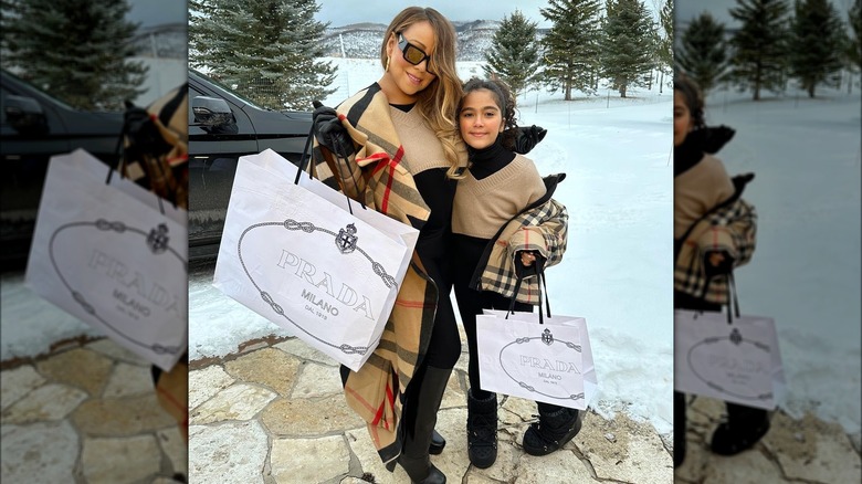 Mariah Carey and Monroe Cannon pose with shopping bags