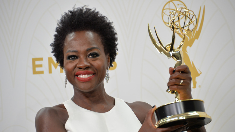 Viola Davis holding up her Emmy