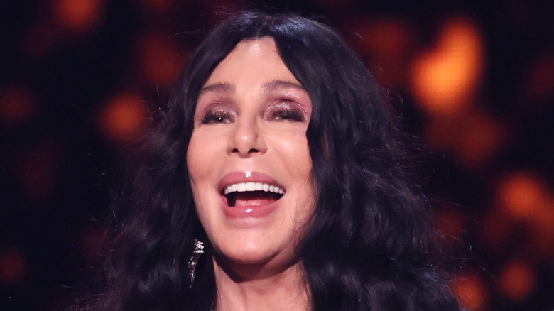 Cher dressed up at a podium at the 2024 Rock n Roll Hall of Fame induction ceremony