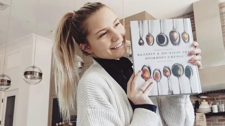 Paige Price holding her cookbook