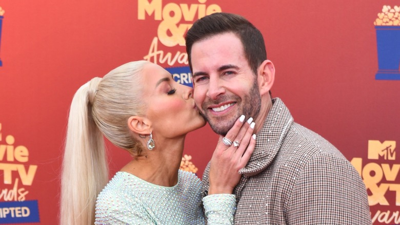 Heather Rae El Moussa kissing Tarek El Moussa's cheek