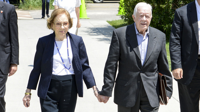 Rosalynn and Jimmy Carter holding hands