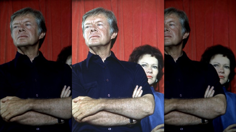 Jimmy Carter standing in front of Rosalynn Carter