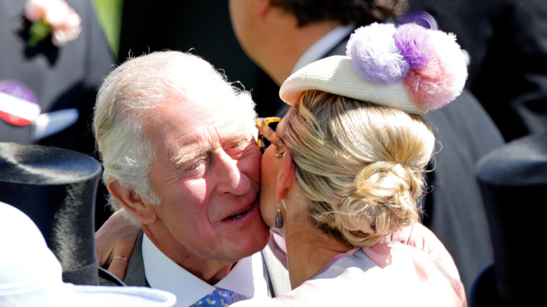 Zara Tindall kissing Charles' cheek 