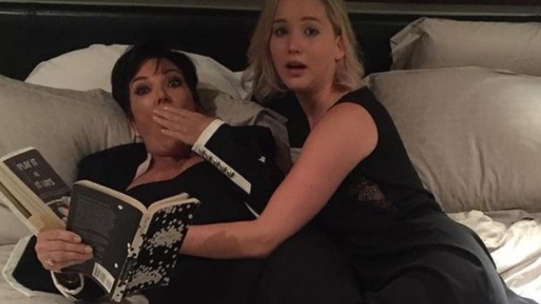 Kris Jenner and Jennifer Lawrence lying in hotel bed together