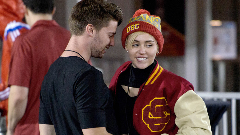 Patrick Schwarzenegger and Miley Cyrus at a USC game in December 2014