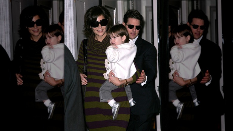 Katie Holmes smiles with husband Tom Cruise and daughter Suri