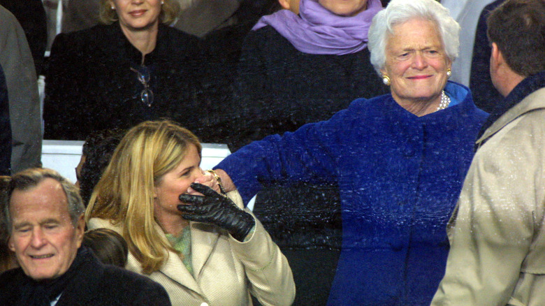 Barbara Bush covering Jenna Bush's mouth