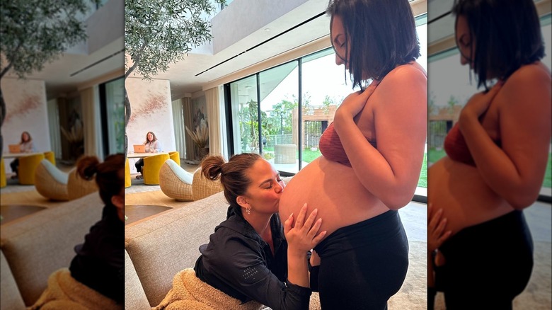 Chrissy Teigen kissing her surrogate's pregnant belly