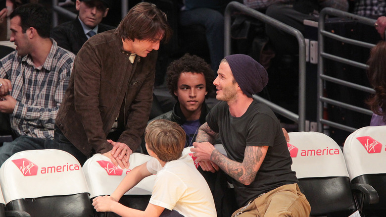 Tom Cruise and David Beckham talking at a Lakers game