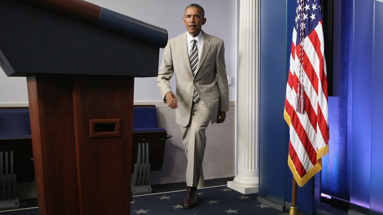 obama walking to podium in tan suit